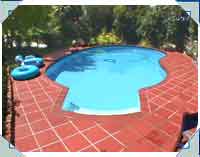 Nice RIO and surrounds transformed this un-used yard into a recreational paradise. This Howick (Auckland) pool is built on a cliff edge with retaining walls supporting the far end.